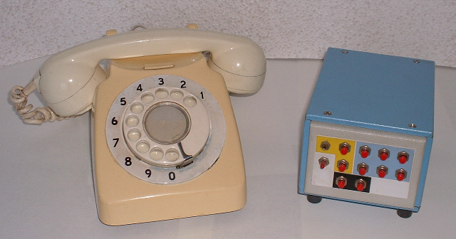 dial telephone next to rectangular box of similar size