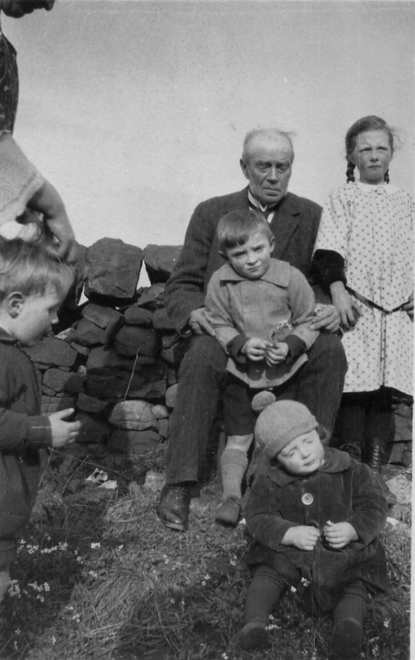 old man on farm wall with four children