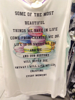 T-shirt decorated with macarons and optimistic message