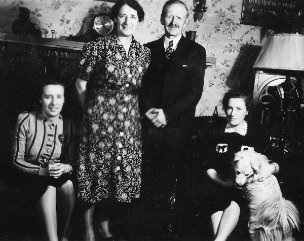 family group and dog inside house