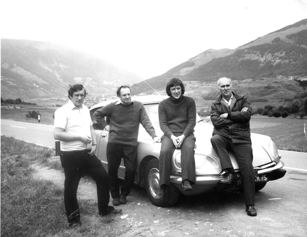men sitting on car bonnet