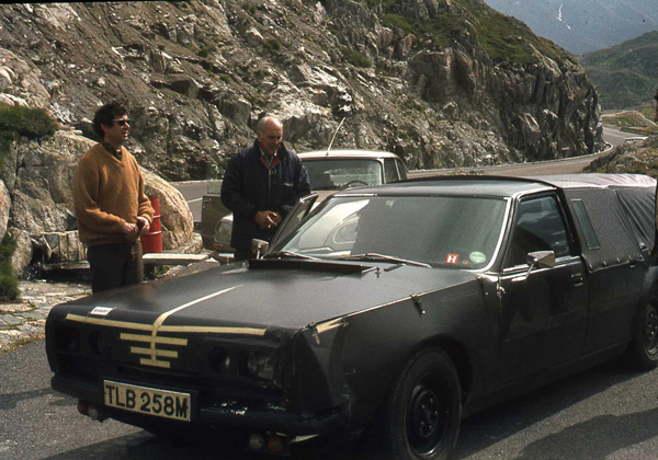 black camouflaged car with yellow tape simulating a grille