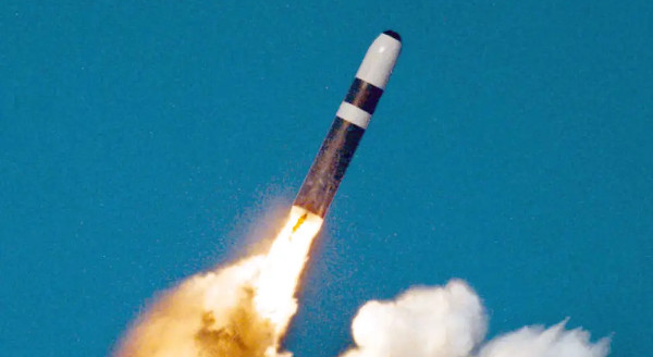 missile with first stage exhausting flame and smoke