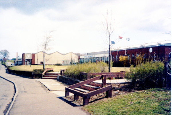 photograph of road with industrial buildings alongside