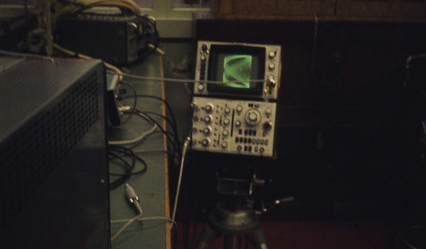 man adjusts radio on workbench