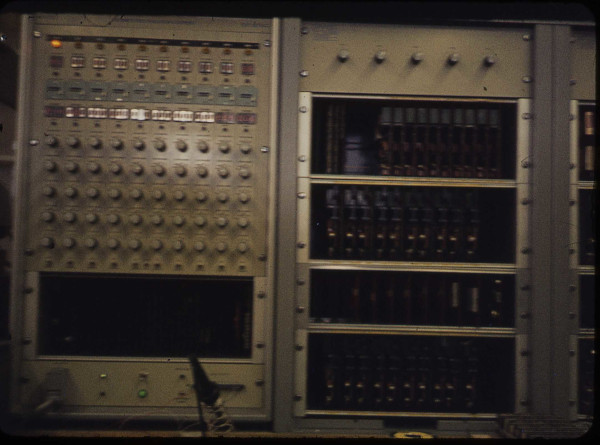 a pair of electronic equipment racks on a bench
