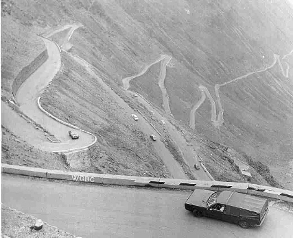 cars descending hair-pin bends