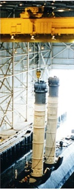 two loading tubes fitted with hoists locked onto submarine