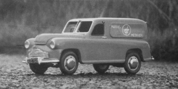 model of a van pictured on a real road